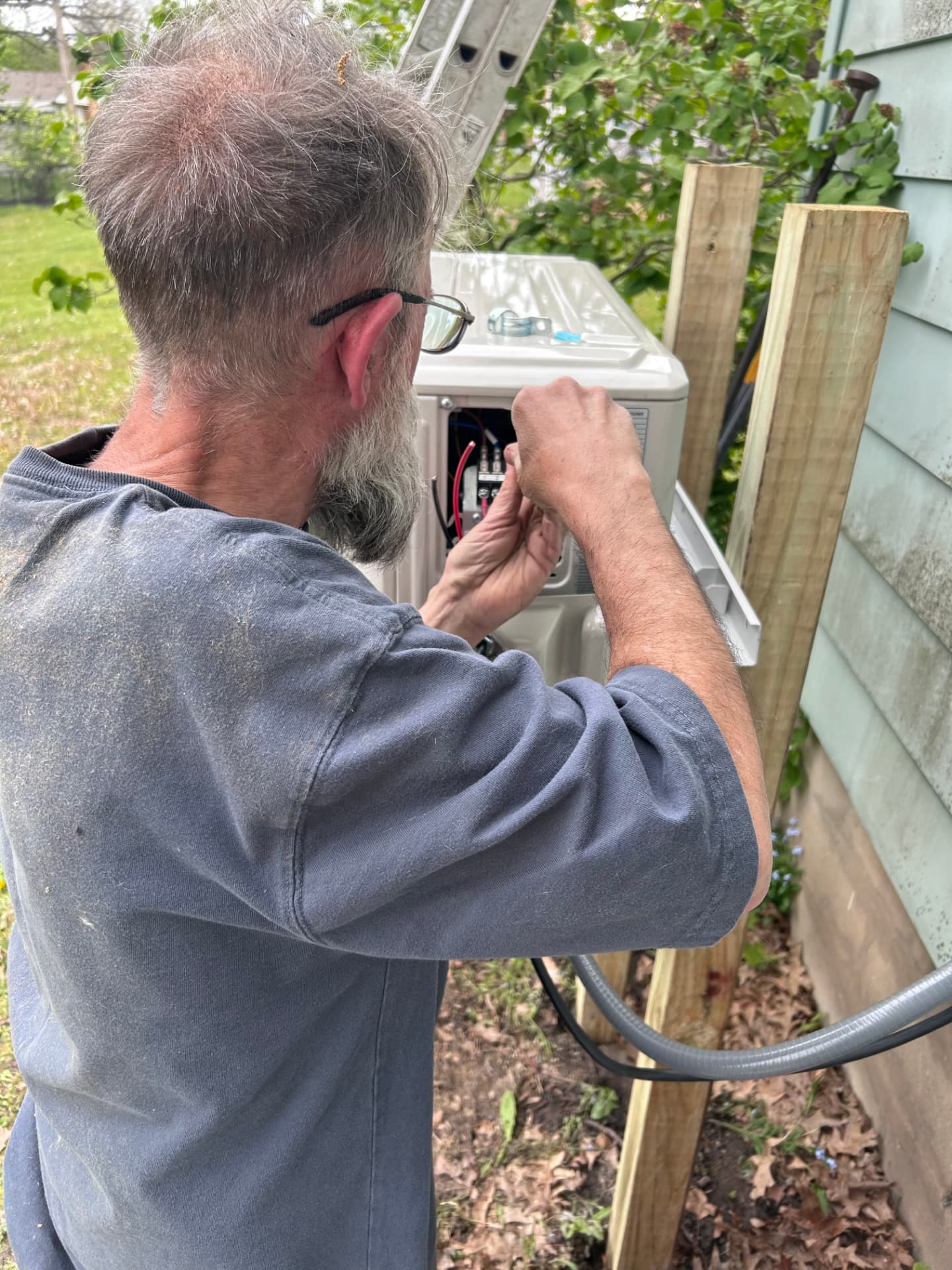 Electrician wiring the disconnect on a residential mini-split condenser unit